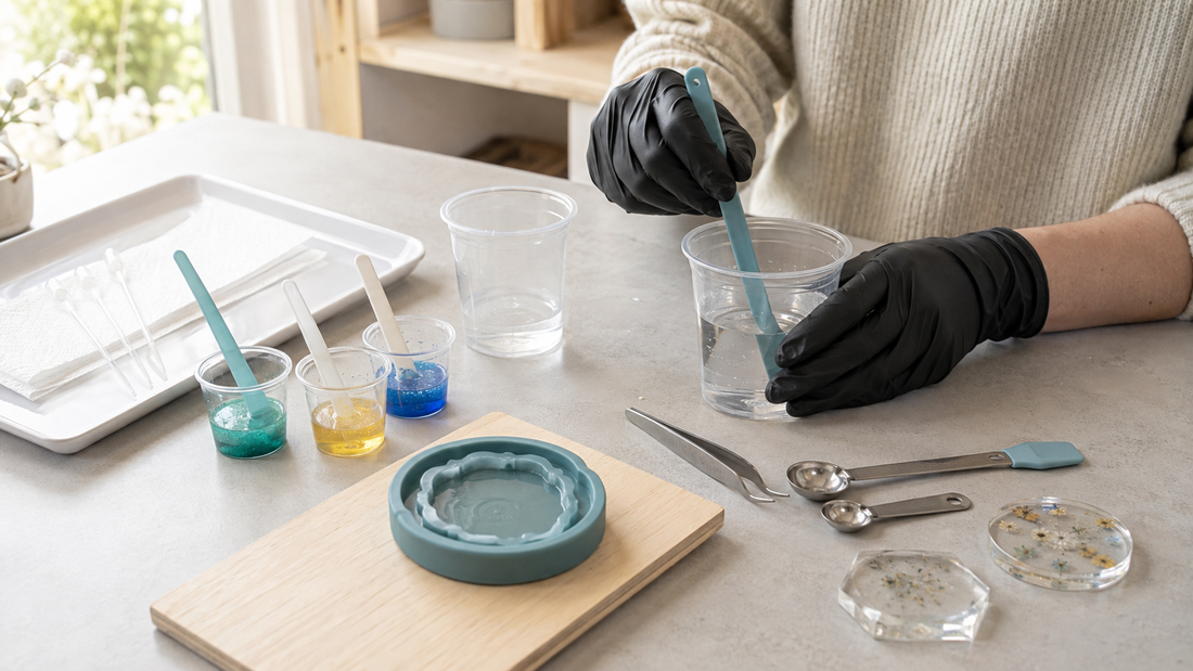 Gloved resin maker using mixing cups and silicone tools on a tidy daylight craft bench