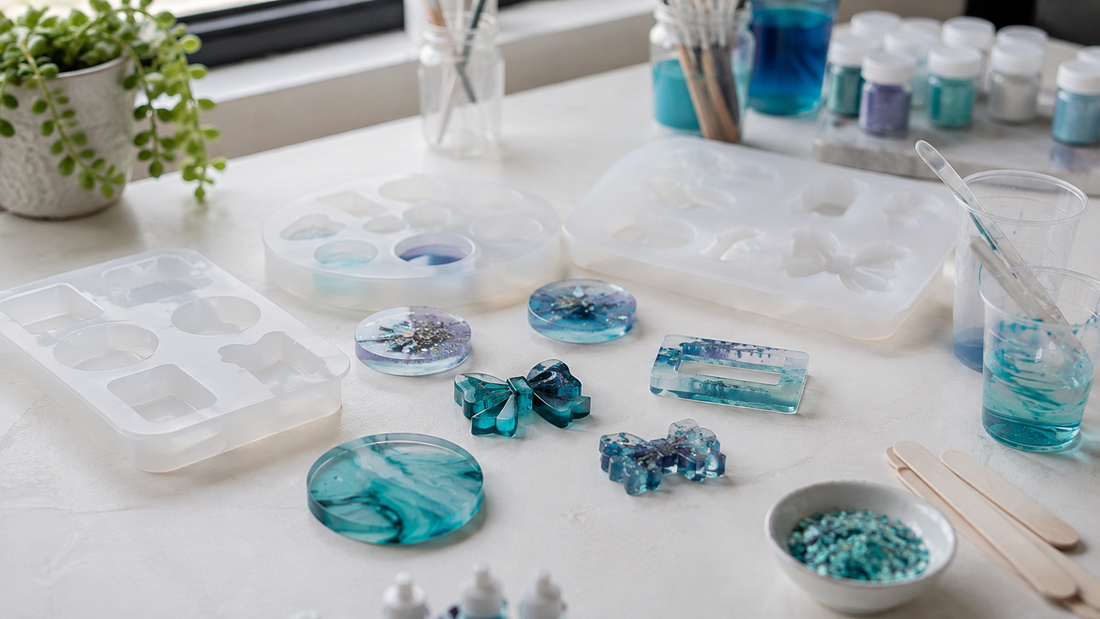 Colourful decorative resin shapes arranged beside silicone casting moulds on a tidy craft workspace